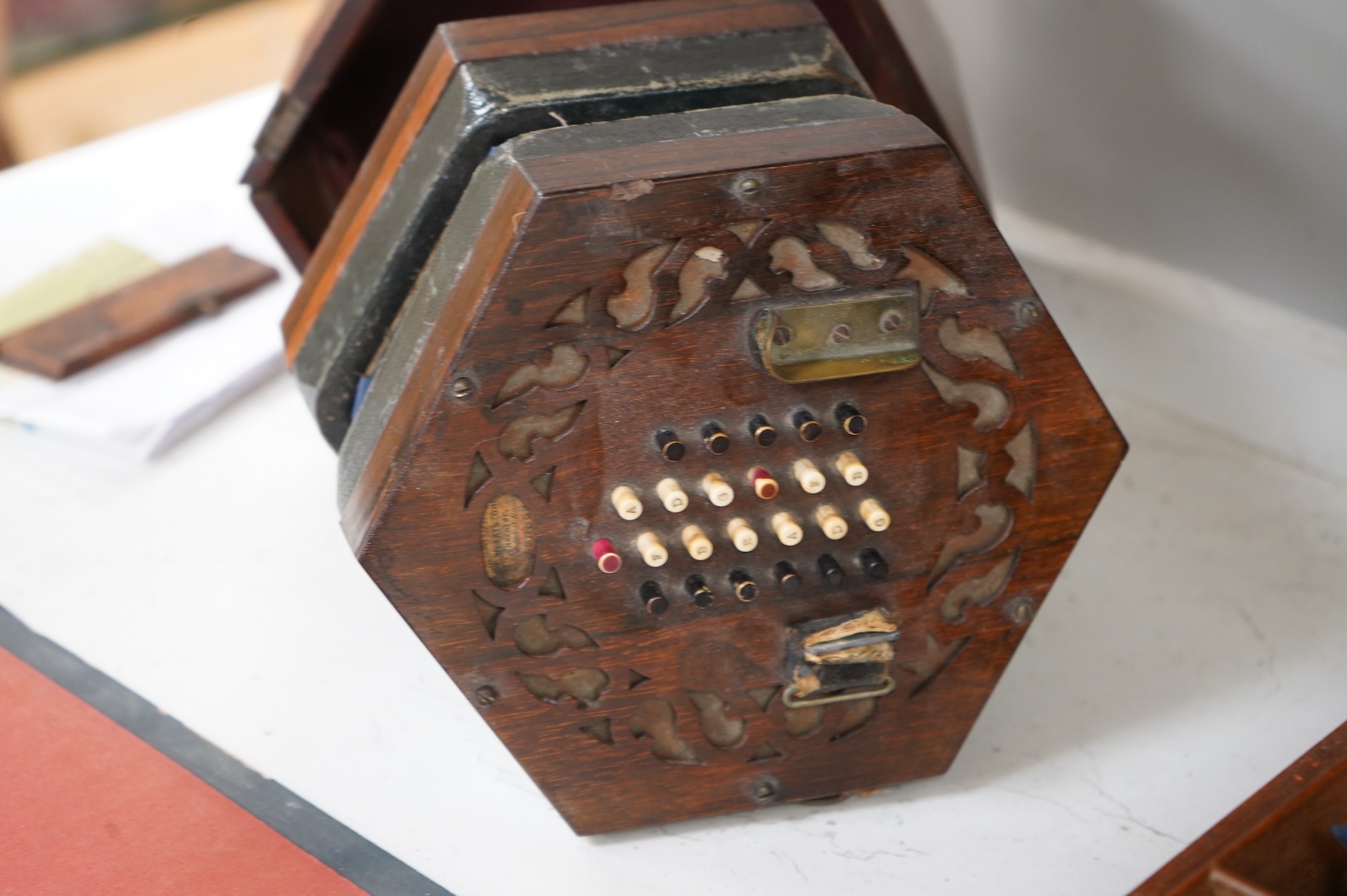 A Wheatstone mahogany cased 48 key rosewood and leather and paper bellows concertina, 18cm wide